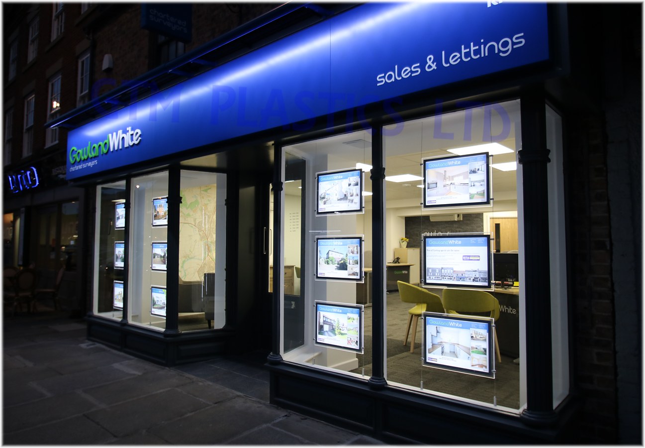 Estate agent shopfront on the high street showcasing property listings using A3 landscape LED light-pockets