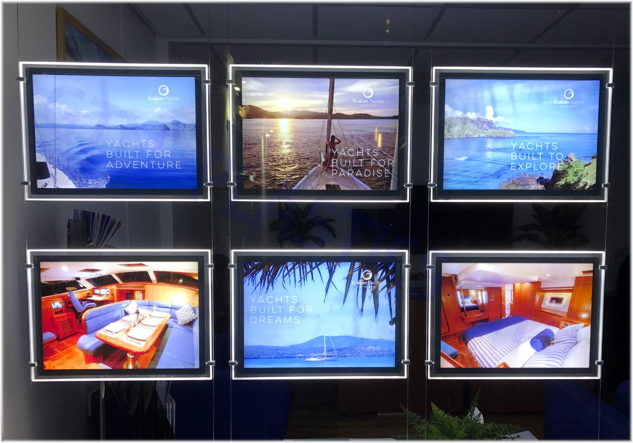 Yacht broker window display featuring LED light-pockets showcasing luxury listings