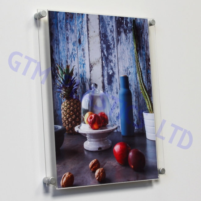 Wall mounted poster holder using stand-off clamps - displaying a poster