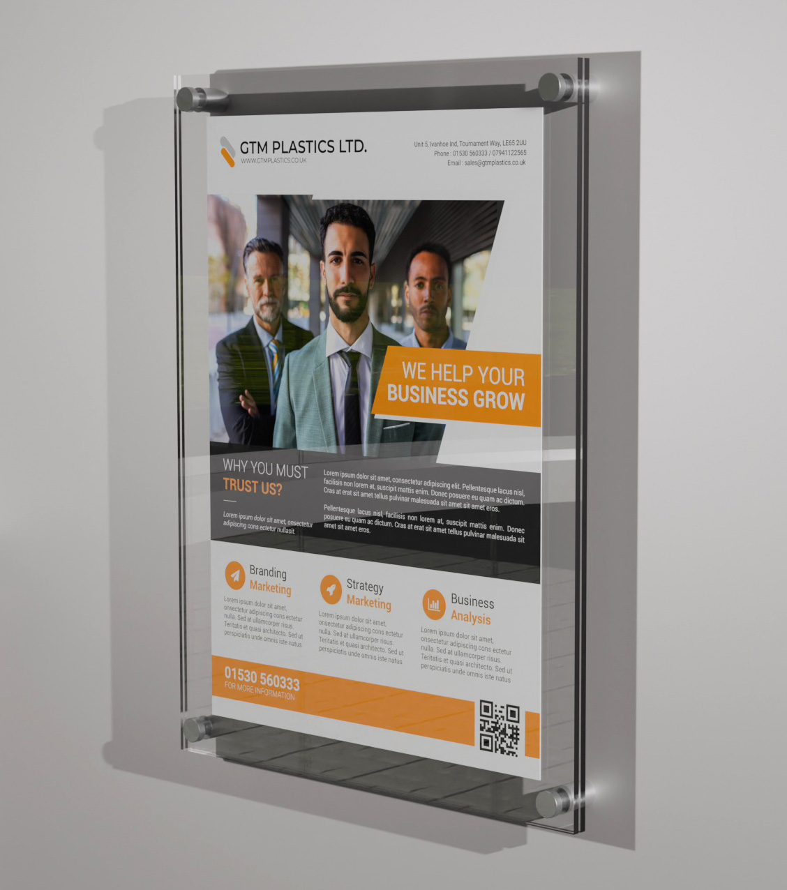 A poster sandwiched between two acrylic panels. Four stand-off clamps pass through the holes at the corners of the panels to attach the display to the wall.